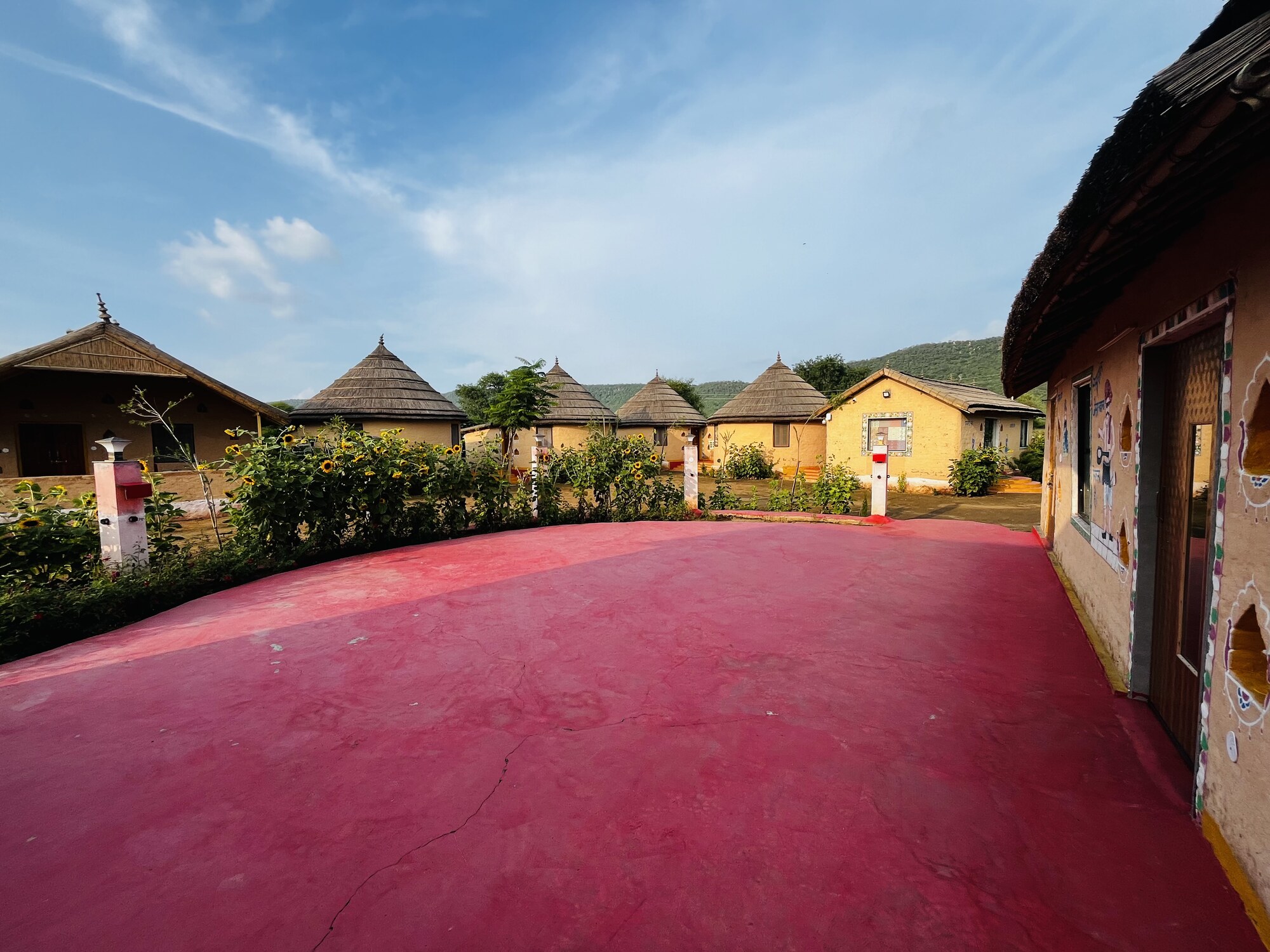 Facade of a traditional mud cottage at Sariska Tiger Lodge